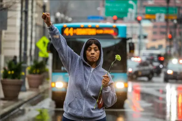  ?? Andrew Rush/Post-Gazette ?? A woman shows her support for the crowd of about 1,000, many of them students, as they march Monday in Downtown. They had been at a rally protesting the acquittal of former East PIttsburgh police Officer Michael Rosfeld in the killing of Antwon Rose II.