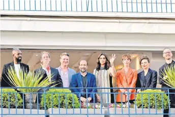  ?? — AFP photo ?? French actor and President of the Jury of the 75th Cannes Film Festival Vincent Lindon (second le ) blows kisses while standing with (from le ) members of Jury French director Ladj Ly, US film director Jeff Nichols, Iranian director Asghar Farhadi, Indian actress Deepika Padukone, British actress Rebecca Hall, Italian actress Jasmine Trinca and Norwegian film director Joachim Trier on the balcony of the Grand Hya Cannes Hotel Martinez on the eve of the opening ceremony of the 75th edition of the Cannes Film Festival in Cannes, southern France.