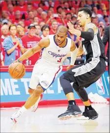 ??  ?? Los Angeles Clippers guard Chris Paul (left), drives past San Antonio Spurs guard Danny Green during the second half of Game 7 in a first-round NBA bas
ketball playoff series on May 2 in Los Angeles. (AP)