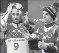  ?? THE CANADIAN PRESS/NATHAN DENETTE ?? Tristan Walker, left, and Justin Snith of Canada react after competing in heat four of men’s luge doubles during the 2018 Olympic Winter Games in Pyeongchan­g, South Korea, Wednesday. Walker and Snith finished fifth.