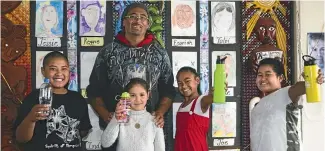  ?? PHOTOS: ROSA WOODS/STUFF ?? Glenview School in Cannons Creek, Porirua has a water-only policy. From left, Bernard Aulemoe, Nagham El Masri, Lester Mohi (deputy principal) Yasmin Koro and George Tapuoti with their water bottles.