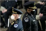  ?? ERIN SCHAFF — THE NEW YORK TIMES VIA AP ?? Capitol Police Acting Chief Yogananda Pittman, right, departs a ceremony memorializ­ing U.S. Capitol Police officer Brian Sicknick, as an urn with his cremated remains lies in honor on a black-draped table at the center of the Capitol Rotunda on Feb. 3 in Washington.