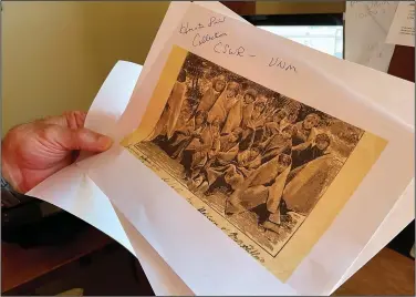  ?? (File Photo/AP/Susan Montoya Bryan) ?? Adjunct history professor and research associate Larry Larrichio holds on July 8 a copy of a late 19th century photograph of pupils at an Indigenous boarding school in Santa Fe during an interview in Albuquerqu­e, N.M.