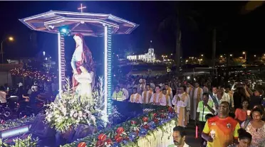  ??  ?? Walk of faith: The float carrying the statue of St Anne and the Blessed Virgin Mary followed by thousands in Bukit Mertajam.