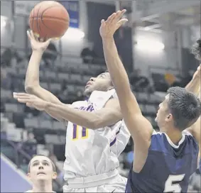  ??  ?? mekeel Christian’s ozzy dejesus guards troy’s nazaire merritt as he takes a shot during their Class A Sectional semifinal on thursday night at Cool insuring Arena in Glens falls. merritt finished with 19 points. dejesus scored 26 in defeat.