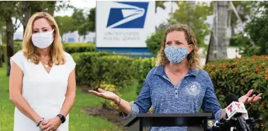  ?? MATIAS J. OCNER mocner@miamiheral­d.com ?? Democratic U.S. Reps. Debbie Mucarsel-Powell, left, and Debbie Wasserman Schultz speak during a press conference near the United States Postal Service mail distributi­on facility in Opa-locka on Tuesday.