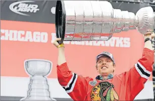  ?? AP PHOTO/NAM Y. HUH, FILE ?? Chicago Blackhawks center Brad Richards holds up the Stanley Cup Trophy during a rally at Soldier Field for the NHL Stanley Cup hockey champions in Chicago in June 2015. Two-time Stanley Cup-winning forward Brad Richards is retiring after 15 NHL seasons.