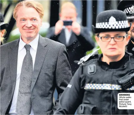  ??  ?? GRINNING Whyte walks free under police guard. Picture: Tony Nicoletti