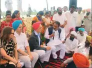  ??  ?? Norway’s ambassador Nils Ragnar Kamsvag (in pink turban) surrounded by villagers in Punjab.