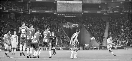  ??  ?? Barcelona’s Lionel Messi scores during the Spanish league football match RCD Espanyol against FC Barcelona at the RCDE Stadium in Cornella de Llobregat. — Reuters photo