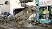  ?? Picture: REUTERS/ GUGLIELMO MANGIAPANE ?? WRECKED: A moped is lifted up out of the mud on the Italian island of Ischia.