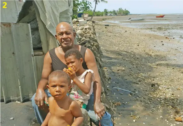  ?? Photos: Nicolette Chambers ?? 2. Navutu Solomoni villager Jale Virivoa with his two grandchild­ren, Aseri and Jona Matea sitting near the village temporary seawal.