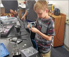  ?? BOB KEELER — DIGITAL FIRST MEDIA ?? Micah Smith fixes a watch in the Souderton Charter School Collaborat­ive’s Last Chance Repair Club.