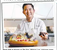  ?? Picture: TIM MARSDEN ?? Head chef at Kiyomi at The Star, Winson Law, prepares some colourful sashimi with truffle shavings.