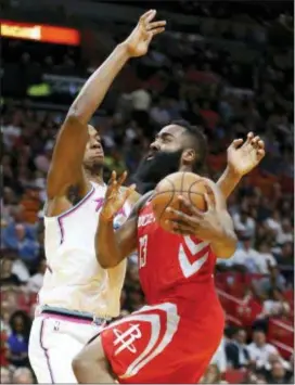  ?? WILFREDO LEE — THE ASSOCIATED PRESS ?? Houston’s James Harden (13) goes up for a shot Hassan Whiteside (21) Wednesday in Miami. against Miami’s