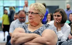  ?? John Heller/Post-Gazette ?? Cecil resident Cathy Pigford listens as zoning board explains its decision.