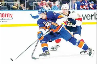  ?? ?? New York Islanders’ Mathew Barzal (13) shoots the puck past Florida Panthers’ Robert Hagg (18) during the second period of an NHL hockey game, on April 19, in Elmont, N.Y. (AP)