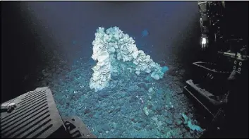  ?? NOAA OFFICE OF EXPLORATIO­N AND RESEARCH/HOHONU MOANA 2015 VIA AP ?? A massive sponge sits at a depth of about 7,000 feet in the Papahanaum­okuakea Marine National Monument off the shores of the Northweste­rn Hawaiian Islands. A study published this week in the scientific journal Marine Biodiversi­ty described the massive...