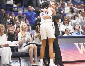  ?? Jessica Hill / Associated Press ?? UConn coach Geno Auriemma embraces Napheesa Collier after she exited Monday’s win over South Carolina in Hartford.