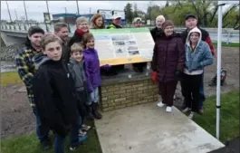  ?? RECORD STAFF ?? Relatives of Jonas Berge gather around a plaque commemorat­ing the settlement of German Mills in Kitchener, Saturday.