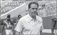  ?? AP/VASHA HUNT ?? Alabama Coach Nick Saban, walking off the field after Saturday’s media and fan day, contends he didn’t offer a job to ex-Ohio State assistant Zach Smith last year.