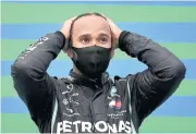  ?? AFP ?? Mercedes driver Lewis Hamilton gestures on the podium at the Hungarian Grand Prix.