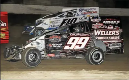  ??  ?? Craig Whitmoyer (99) works his way to the front of the field on June 3 at Grandview Speedway. Below, Whitmoyer poses in victory lane after his win.