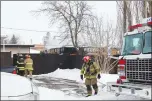  ?? Herald photo Tim Kalinowski ?? Lethbridge Fire and Emergency Services responded to a large garage fire on 14 Ave South Sunday afternoon. The garage was fully engulfed and destroyed, but firefighte­rs were able to mostly contain the blaze to the one structure.