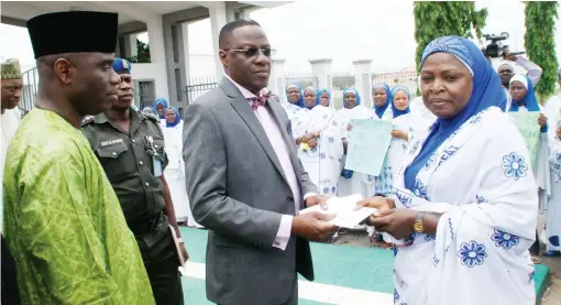  ?? PHOTO
GOVT HOUSE ?? NASFAT Women Leader, Hajiya Ummuhani Abdulrahma­n (right), presenting a letter of protest over the abduction of school girls in Borno to Governor Abdulfatah Ahmed of Kwara, during their protest to Government Housein Ilorin yesterday.