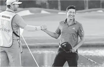  ?? PHELAN M. EBENHACK AP ?? Collin Morikawa (right) celebrates with caddie J.J. Jakovac after winning the WGC Workday Championsh­ip.