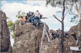  ?? Associated Press photo ?? Director Larysa Kondracki, lower centre, speaks to crew members while shooting on location for “Picnic at Hanging Rock” in Woodend, Victoria, Australia, in this 2017 handout photo.