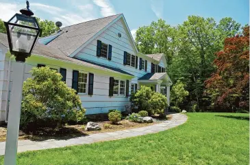  ?? JayLazarin/Getty Images ?? A 1970s American Colonial style suburban home is seen in Connecticu­t.