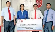  ??  ?? CA Sri Lanka President Jagath Perera presenting the scholarshi­p to Kaushalya Subashani Dabare of Musaeus College, Colombo who was adjudged island second in the commerce stream at the 2017 GCE Advanced Level exam. Also in the picture are CA Sri Lanka...