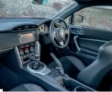  ??  ?? 1 Snug cabin features a smaller sports steering wheel and updated trim materials. 2 Rear seats remain a token gesture, but do provide additional packing space should the boot be too small. 3 Bi-colour rear wing and revisions to the bumper and...