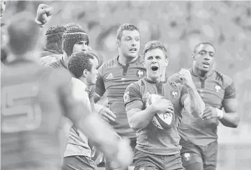  ??  ?? France’s scrum-half Rory Kockott (2nd R) and teammates reacts at the final whistle blow, after defating Australia during the internatio­nal rugby union Test match France vs Australia at the Stade de France stadium in Saint-Denis, outside Paris, on...
