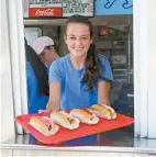  ?? Connecticu­t Office of Tourism ?? A staff member at the Sea Swirl, located in historic Mystic, displays a tray of seafood ( photo taken precoronav­irus). The family friendly restaurant follows all COVID- 19 regulation­s, and features a large selection of seafood, hot dogs, sandwiches, ice cream, and more.