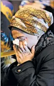  ?? EDUARDO MUNOZ ALVAREZ/AP ?? A woman mourns Wednesday during the funeral of Mindel Ferencz, who was killed in a shooting in Jersey City, N.J.