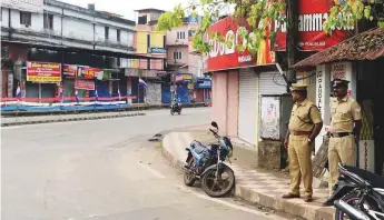  ?? AFP ?? Police stand guard during a statewide strike called by Hindu groups in Adur in Kerala yesterday, in response to the opening of the nearby Sabarimala temple to women.