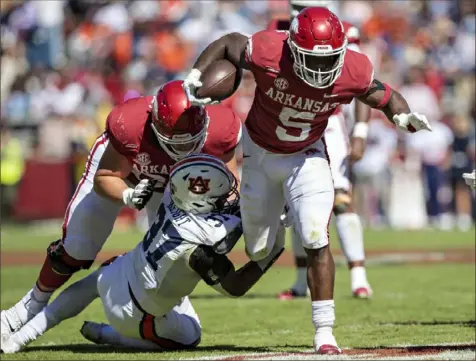  ?? Wesley Hitt/Getty Images ?? Arkansas’ Raheim Sanders runs through a tackle in a 38-23 loss to Auburn this season. The Razorbacks have the 13th-best rushing offense in FBS, averaging 217.3 yards per game.