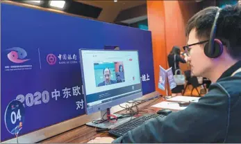  ?? PROVIDED TO CHINA DAILY ?? A staff member from Bank of China offers tailored financial services to businesspe­ople during the event.