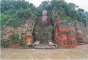  ?? AFP via Getty Images ?? It’s first time in at least 70 years that water has reached the foot of the Giant Buddha in Leshan.