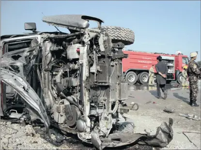  ?? PICTURE: EPA ?? AFTERMATH: Afghan security officials inspect the scene of an explosion that targeted a vehicle of the British embassy, in Kabul, yesterday. At least five people were reported to have died in the blast.