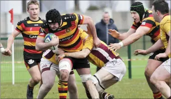  ??  ?? Ross Hickey is challenged by two Bruff players.