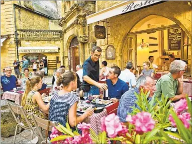  ?? DOMINIC ARIZONA BONUCCELLI/RICK STEVES’ EUROPE PHOTOS ?? Lingering in outdoor cafes is the norm in France — eat long and well. A good meal is a three-hour joyride for the senses.