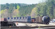  ?? ASSOCIATED PRESS ?? Train cars filled with sewage sludge from New York City sit in a railyard in Parrish, Ala., earlier this month. The cars were finally emptied this week.