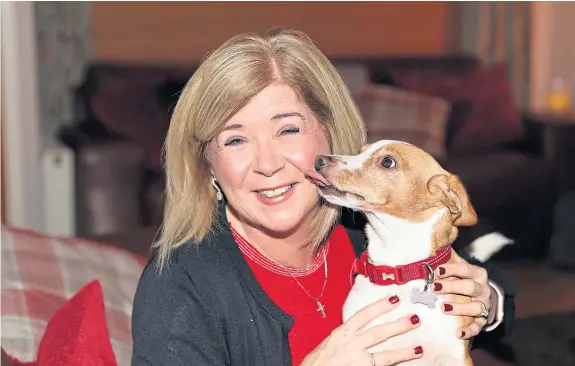  ??  ?? Linda McDonald at home with her Jack Russell, Betsy, who was with her at the time of the brutal attack.