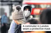  ??  ?? A commuter in London wears a protective mask