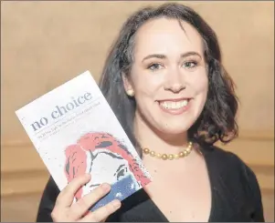  ?? MITCH MACDONALD/THE GUARDIAN ?? Journalist Kate McKenna holds up a copy of her first book, “No Choice: The 30-Year Fight for Abortion on Prince Edward Island”, during the launch at the Rodd Charlottet­own Hotel Sunday night.