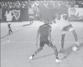  ??  ?? Flashback-Shem Porter (right) of Alexander Village trying to dribble past Sheldon Shepherd of Sparta Boss during their group clash in the Guinness Cage Street-ball Championsh­ip at the Haslington Tarmac.