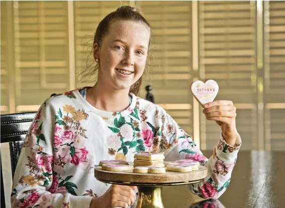  ?? Photo: Nev Madsen ?? EDIBLE FUNDRAISIN­G: Emerald Michael, 14, made cookies for the Toowoomba Hospital Foundation's Mothers Day high tea which will raise funds for BreastScre­en Queensland’s Toowoomba service.